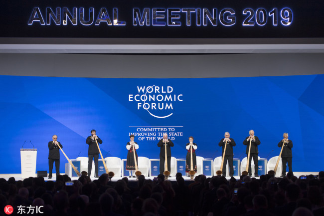 Alphorn players perform on stage before the opening session in the Congress Hall during the annual meeting of the World Economic Forum in Davos, Switzerland, Tuesday, Jan. 22, 2019. [Photo: IC]