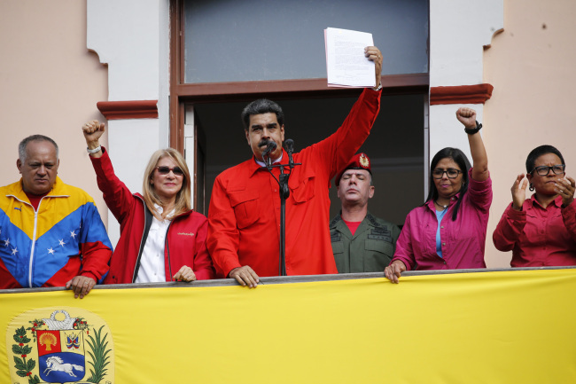 Venezuelan President Nicolas Maduro announces he is breaking relations with the U.S., to supporters from a balcony at Miraflores presidential palace in Caracas, Venezuela, Wednesday, Jan. 23, 2019. [Photo: AP]