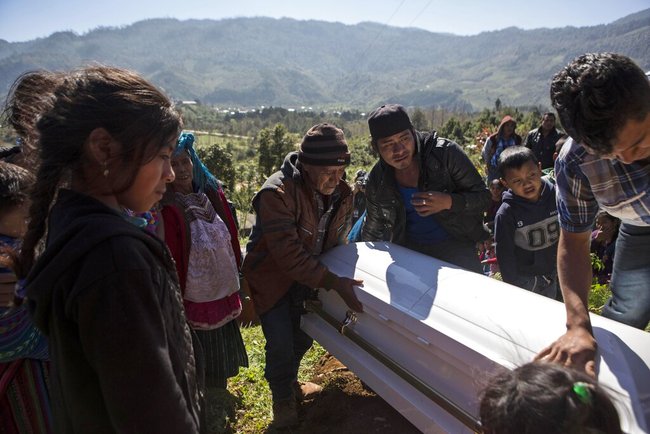 People lower the coffin of Felipe Gomez Alonzo, an 8-year-old Guatemalan boy who died in U.S. custody, into his tomb at the cemetery in Yalambojoch, Guatemala, Sunday, Jan. 27, 2019. On Christmas Eve, the 8-year-old boy became the second Guatemalan child to die while in custody near the Mexican border. [Photo: AP]