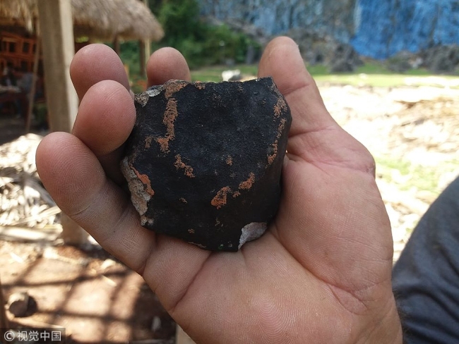 Handout picture released by Tele Pinar, a local television station, showing an alleged piece of a meteorite that fell in Cuba on February 1, 2019, taken in Vinales, in the Cuban western province of Pinar del Rio. [Photo: VCG]