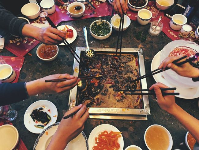 Hot pot is popular in Sichuan Province. With a history tracing itself to the Warring States Period (475-221BCE), hot pot lets several people share a meal with one large, boiling bowl. Photos show a family sharing a hot pot meal to ring in the "Year of the Pig," Xichang, Sichuan Province, February 4, 2019. [Photo: China Plus/Jiang Yi]