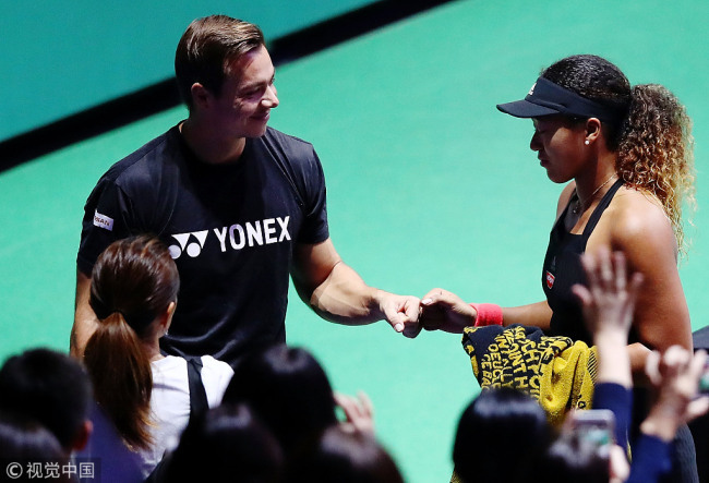 Naomi Osaka of Japan is comforted by her coach Sascha Bajin after retiring from her Women's singles match against Kiki Bertens of the Netherlands during day 6 of the BNP Paribas WTA Finals Singapore presented by SC Global at Singapore Sports Hub on October 26, 2018 in Singapore. [Photo: VCG]