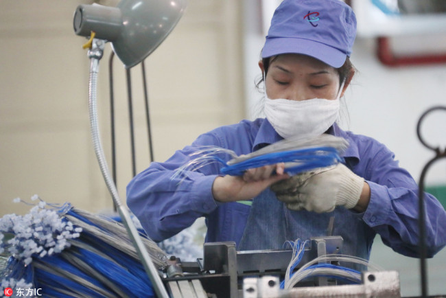A woman works in a factory in Huai'an, Jiangsu Province, December 21, 2018. [Photo: IC]