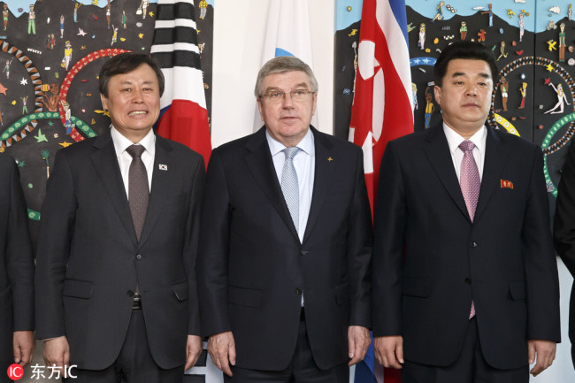 South Korean Sports Minister Do Jong-hwan, left, International Olympic Committee (IOC) president Thomas Bach, center, from Germany, and North Korea's Olympic Committee President and sports minister Kim Il Guk, right pose for the grapher prior a meeting with the IOC about their bid to co-host the 2032 Summer Olympics, at the IOC Headquarters in Lausanne, Switzerland, Friday, February 15, 2019. [Photo: IC]