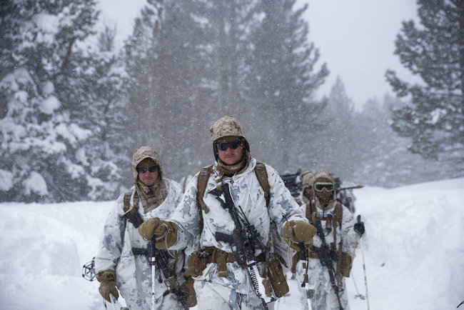 U.S. Marines walk along a snow-covered trail during their advanced cold-weather training at the Marine Corps Mountain Warfare Training Center Sunday, Feb. 10, 2019, in Bridgeport, Calif. After 17 years of war against Taliban and al-Qaida-linked insurgents, the military is shifting its focus to better prepare for great-power competition with Russia and China, and against unpredictable foes such as North Korea and Iran. [Photo: AP]