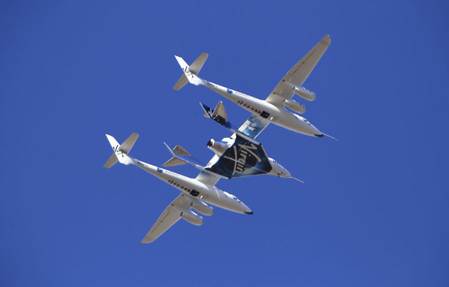 Virgin Galactic's VSS Unity rocket plane flown into the atmosphere before launching Friday, Feb. 22, 2019, in Mojave, Calif. Virgin Galactic says its rocket plane has reached space for a second time in a test flight over California on Friday. In addition to two pilots, the spacecraft carried a third crewmember to evaluate the cabin from a passenger perspective. [Photo: AP/Matt Hartman]