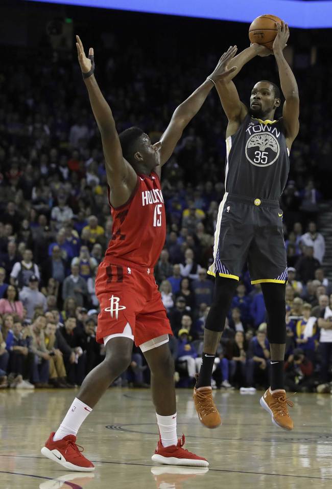 Golden State Warriors' Kevin Durant, right, shoots over Houston Rockets' Clint Capela, left, in the second half of an NBA basketball game Saturday, Feb. 23, 2019, in Oakland, Calif. [Photo: AP/Ben Margot]