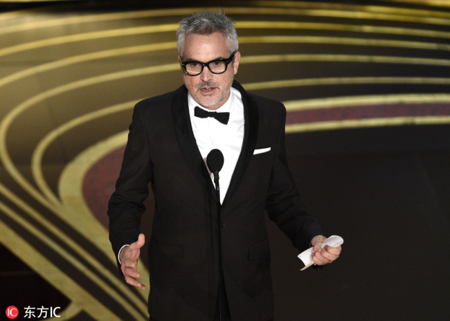 Alfonso Cuaron accepts the award for best director for "Roma" at the Oscars on Sunday, Feb. 24, 2019, at the Dolby Theatre in Los Angeles. [Photo: AP/Chris Pizzello/Invision via IC]