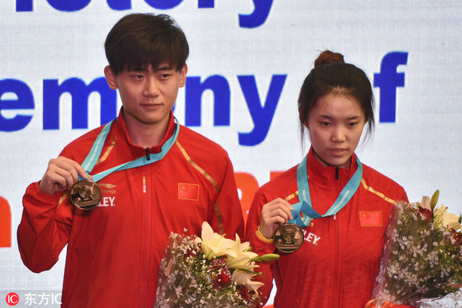 China's Liu Yukun (Left) and Zhao Ruozhu present their mixed 10m Air Rifle gold medals at ISSF World Cup at Karni Singh Shooting Ranges on February 27, 2019 in New Delhi, India. [Photo: IC]