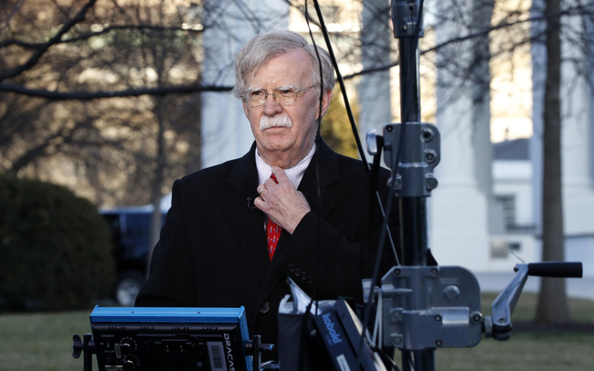 National security adviser John Bolton straightens his tie before an interview at the White House in Washington on March 5, 2019. [Photo: AP/Jacquelyn Martin]