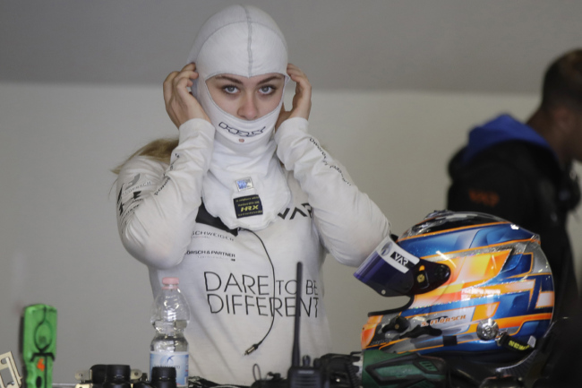 Formula 3 pilot Sophia Floersch prepares her balaclava in the garage before driving for a Van Amersfroot Racing team test car at the Monza racetrack, northern Italy, Wednesday, March 6, 2019. Floersch started training in Monza just four months after her severe race crash in Macao last year which caused a broken cervical. [Photo: AP]