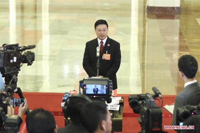 Tong Jianming, the deputy procurator-general of the Supreme People's Procuratorate, is interviewed after the third plenary meeting of the second session of the 13th National People's Congress at the Great Hall of the People in Beijing on Tuesday, March 12, 2019. [Photo: Xinhua/Yin Gang]