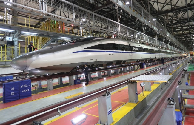 A mechanic inspects a high-speed train during the Spring Festival travel rush, the "Chunyun," at a maintenance station in Kunming, Yunnan province, January 21, 2019. [Photo:IC]