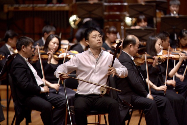 Zhang Xuguang, a musician with the China Broadcasting Chinese Orchestra is playing the Huqin. [Photo Courtesy of: Zhang Xuguang]