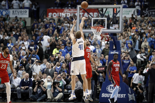Dallas Mavericks forward Dirk Nowitzki (41) shoots as New Orleans Pelicans’ Kenrich Williams (3) defends and Pelicans’ Julius Randle (30) and Anthony Davis (23) watch in the first half of an NBA basketball game in Dallas, Monday, March 18, 2019. With the basket, Nowitzki became the NBA's sixth-leading scorer. [Photo: AP]