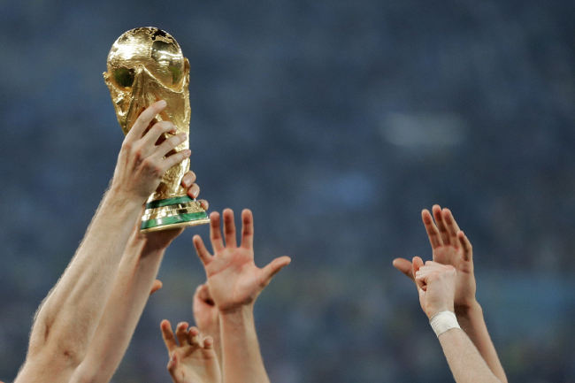 In this Sunday, July 13, 2014 file photo, German players reach out to touch the trophy after the World Cup final soccer match between Germany and Argentina at the Maracana Stadium in Rio de Janeiro, Brazil. [File photo: AP]