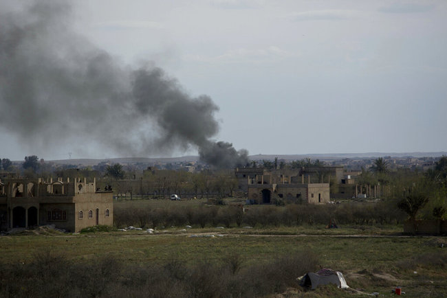 Smoke rises from a strike on Baghouz, Syria, on the Islamic State group's last piece of territory on Friday, March 22, 2019. [Photo: AP/Maya Alleruzzo]