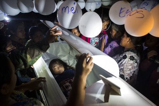 Family members pay their final respects to 7-year-old Jakelin Caal Maquin during a memorial service in her grandparent's home in San Antonio Secortez, Guatemala, on Monday, Dec. 24, 2018.[Photo: AP]