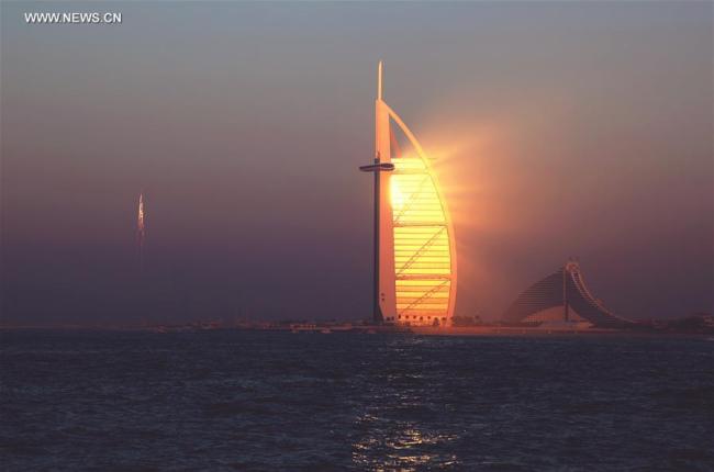 The hotel Burj Al-Arab is seen during sunset in Dubai, the United Arab Emirates (UAE), Dec. 30, 2016. The UAE, located at the intersection of the Belt and Road Initiative, is an important partner for China to promote the Belt and Road Initiative. [Photo:Xinhua]