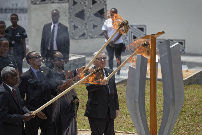 From left to right, Chairperson of the African Union Commission Moussa Faki Mahamat, Rwanda's President Paul Kagame, Rwanda's First Lady Jeannette Kagame, and President of the European Commission Jean-Claude Juncker, light the flame of remembrance at the Kigali Genocide Memorial in Kigali, Rwanda, Sunday, April 7, 2019. [Photo: AP/Ben Curtis]