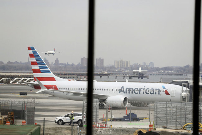In a March 13, 2019 file photo, an American Airlines Boeing 737 MAX 8 sits at a boarding gate at LaGuardia Airport in New York. American Airlines is canceling 115 flights per day through mid-August because of ongoing problems with the Boeing 737 Max aircraft. [File photo: AP/Frank Franklin II]