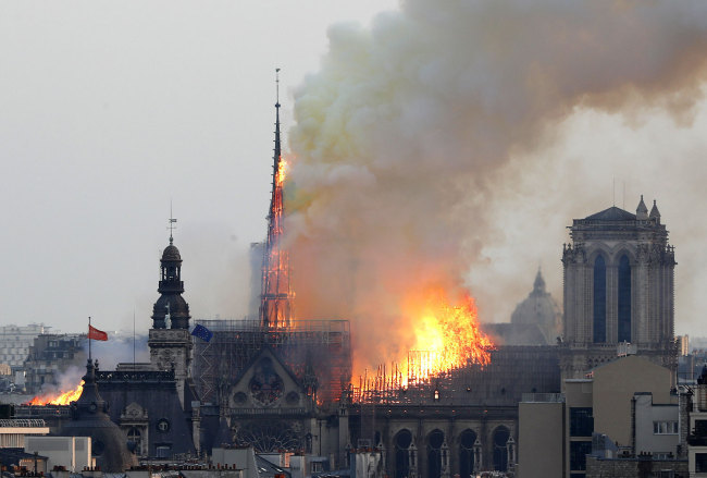 Flames rise from Notre Dame cathedral as it burns in Paris, Monday, April 15, 2019. [Photo:AP]