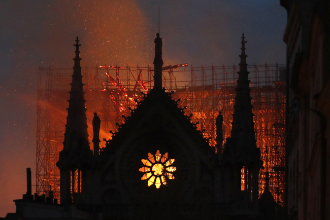 Flames and smoke rise from Notre Dame cathedral as it burns in Paris, Monday, April 15, 2019. [Photo: AP/Thibault Camus]