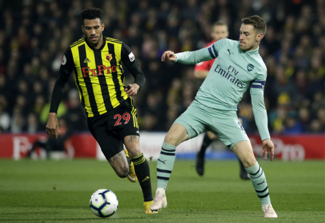Arsenal's Aaron Ramsey vies for the ball with Watford's Etienne Capoue, left, during the English Premier League soccer match between Watford and Arsenal at Vicarage Road stadium in Watford, England on Monday, April 15, 2019. [Photo: AP]