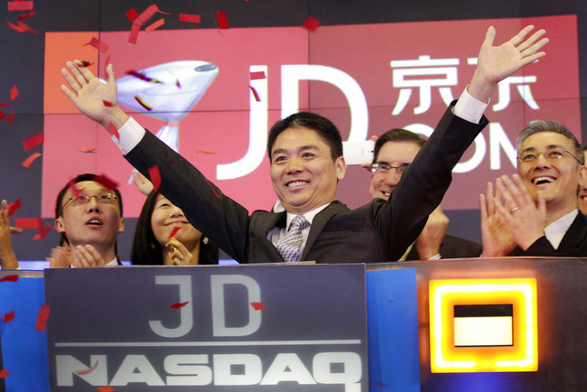 In this file photo taken May 22, 2014, Liu Qiangdong, also known as Richard Liu, CEO of JD.com, raises his arms to celebrate the IPO for his company at the Nasdaq MarketSite, in New York. A woman who said she was raped by Liu filed a lawsuit Tuesday, April 16, 2019, against the billionaire and his company alleging he and other wealthy Chinese executives coerced her to drink during a dinner in the hours before she was attacked. [File photo: AP]