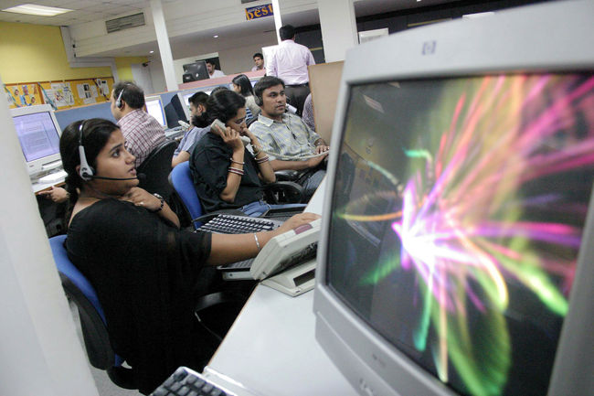 FILE - This file photo taken late 09 May, 2005 shows Indian employees of a call center working during their night shift in Mohali, in India's northern state of Punjab. [Photo: AFP]