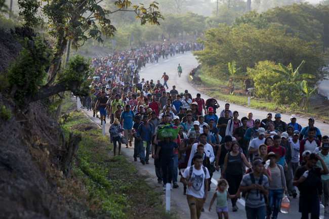 Central American migrants, part of a caravan hoping to reach the U.S. border, move on the road in Escuintla, Chiapas State, Mexico, Saturday, April 20, 2019. Thousands of migrants in several different caravans have been gathering in Chiapas in recent days and weeks. [Photo: AP/Moises Castillo]