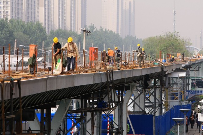 Workers building what's being described as Beijing's first bicycle highway, connecting the Huilongguan residential community in Beijing's northern Changping District with Shangdi, an industrial zone in neighboring Haidian District, April 21, 2019. [Photo: IC]
