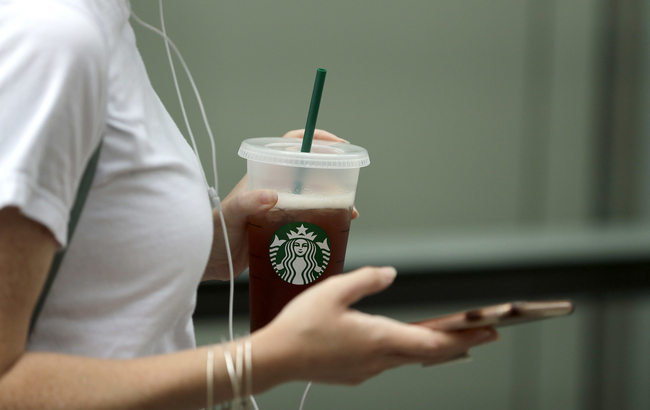 A patron departs a Starbucks cafe in the famed Loop area in downtown Chicago, Illinois, May 29, 2018. [File Photo: AP/Charles Rex Arbogast]