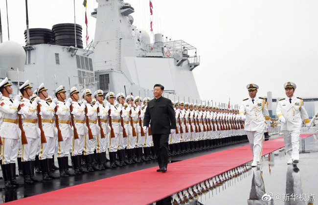 Chinese President and Central Military Commission Chairman Xi Jinping boards the destroyer Xining after inspecting the honor guards of the Chinese People's Liberation Army (PLA) Navy at a pier in Qingdao, Shandong Province on Tuesday, April 23, 2019. [Photo: Xinhua]