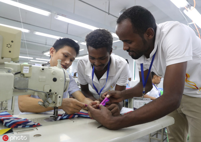 Two Ethiopian nationals are learning at a clothing factory, in Deqing, east China’s Zhejiang Province, on August 30, 2018. It is a part of the Belt and Road Initiative’s economic and trade exchange activities. [File Photo: IC]
