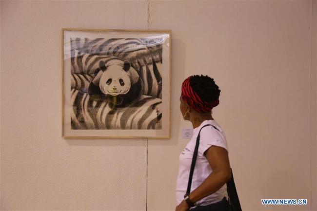 A visitor views an artwork at the second Belt and Road Afro-Sino Art Exchange Exhibition in National Gallery of Zimbabwe in Harare, Zimbabwe, April 29, 2019. The second Belt and Road Afro-Sino Art Exchange Exhibition opened in Zimbabwe's capital Harare Monday evening with more than 120 pieces of art from China and Africa on display. [Photo: Xinhua/Chen Yaqin]