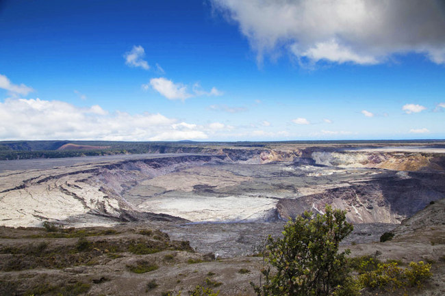 This Aug. 17, 2018 file photo provided by the National Park Service shows Halemaumau Crater and Kilauea Caldera at Kilauea volcano's summit inside Hawaii Volcanoes National Park in Hawaii. A man was seriously injured after crossing a safety barrier and falling 60 to 70 feet into Halemaumau crater on the Big Island. Officials say emergency personnel completed a "high-angle extrication" before a military helicopter airlifted the man in critical condition to Hilo Medical Center. [File Photo: Janice Wei/National Park Service via AP]