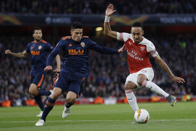 Arsenal's Pierre-Emerick Aubameyang, right, challenges for the ball with Valencia's Gabriel, during the Europa League semifinal first leg soccer match between Arsenal and Valencia at the Emirates stadium in London, Thursday, May 2, 2019. [Photo: AP]