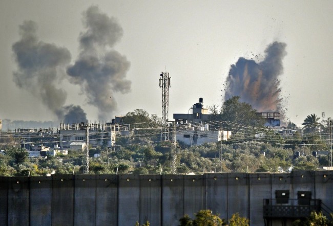 A picture taken from the southern Israeli village of Netiv Haasara shows an explosion and smoke fumes caused by an Israeli airstike across the border in the Gaza Strip on May 4, 2019. [Photo: AFP/Thomas Coex] 