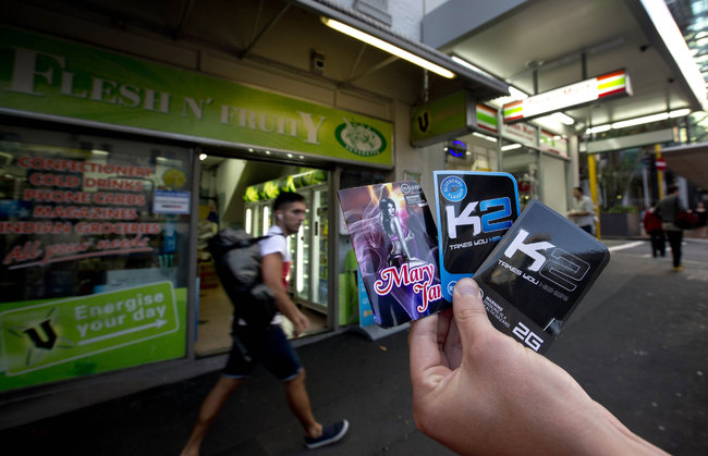 This April 25, 2013 photo shows packets of K2, synthetic cannabis product, held up outside a store in Auckland. New Zealand. [File photo: AP] 