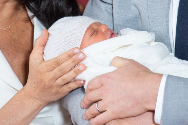 Britain's Prince Harry, Duke of Sussex, and his wife Meghan, Duchess of Sussex, pose for a photo with their newborn baby son in St George's Hall at Windsor Castle in Windsor, west of London on May 8, 2019. [Photo: AFP/Dominic Lipinski]