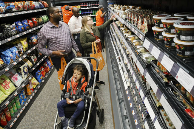 Customers shop in a newly-opened Amazon Go store, Tuesday, May 7, 2019 in New York. [Photo: AP/Mark Lennihan]