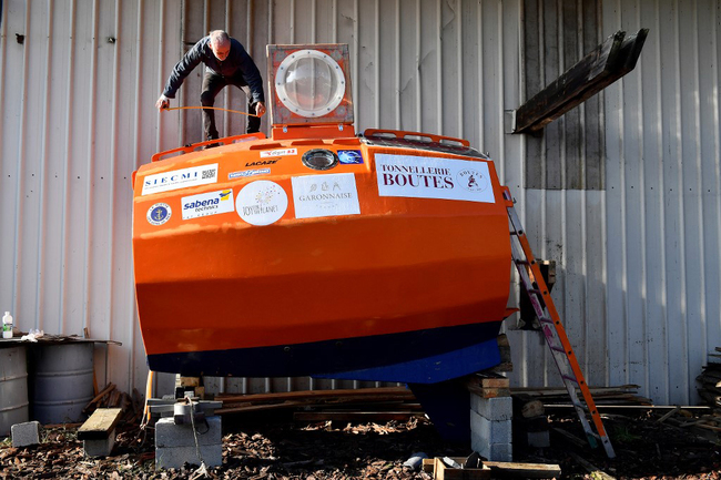 Jean-Jacques Savin works on the construction of a ship made from a barrel at the shipyard in Ares, southwestern France on November 15, 2018. [Photo: AFP]