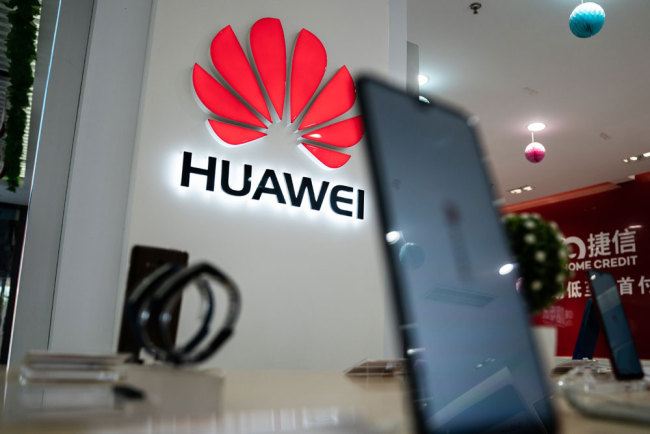 A Huawei logo is displayed at a retail store in Beijing on May 20, 2019. [Photo: AFP/Fred Dufour]