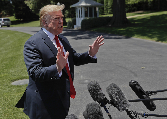 President Donald Trump speaks to members of the media on the South Lawn of the White House in Washington, Friday, May 24, 2019, before boarding Marine One for a short trip to Andrews Air Force Base, Md., and then on to Tokyo. [Photo: AP]