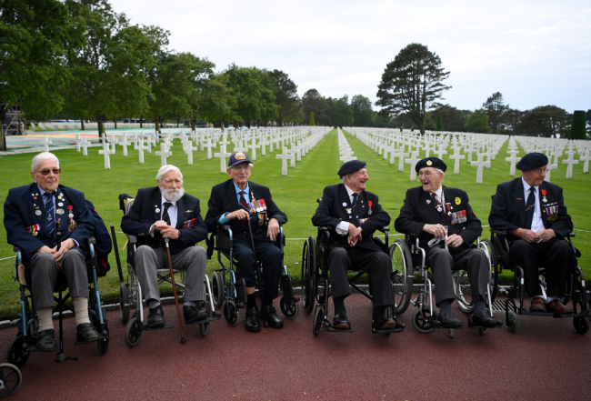 WWII British veterans stand before a remembrance ceremony at The Normandy American Cemetery in Colleville-sur-Mer on June 4, 2019, as part of events for the 75th anniversary of D-Day. [Photo: AFP/Damien Meyer]