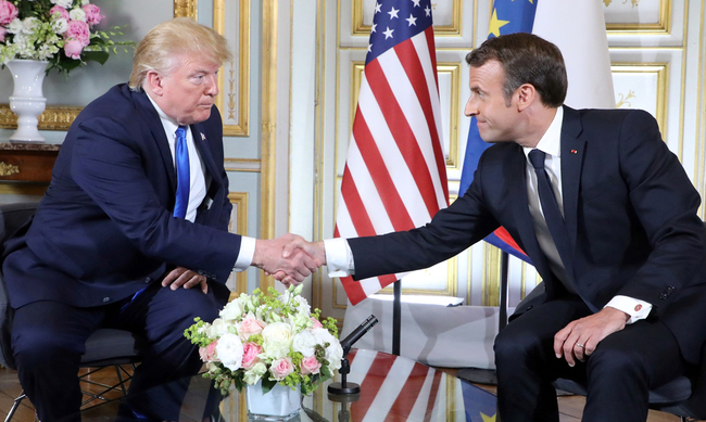 US President Donald Trump (L) and French President Emmanuel Macron shake hands during a meeting at the Prefecture of Caen, Normandy, north-western France, on June 6, 2019, on the sidelines of D-Day commemorations marking the 75th anniversary of the World War II Allied landings in Normandy. [Photo: AFP/Ludovic MARIN]