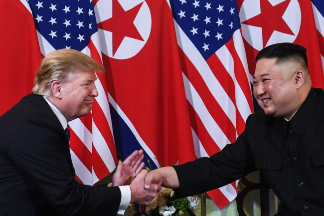 In this file photo taken on February 27, 2019 US President Donald Trump (L) shakes hands with North Korea's leader Kim Jong Un following a meeting at the Sofitel Legend Metropole hotel in Hanoi. [Photo: AFP]