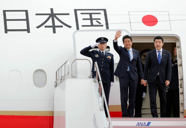 Japan's Prime Minister Shinzo Abe (C) waves to well-wishers upon his departure at Tokyo's Haneda Airport on June 12, 2019. Abe left for a two-day visit to Iran. [Photo: AFP]