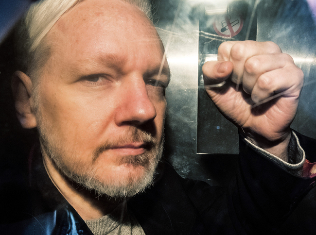 In this file photo taken on May 1, 2019 WikiLeaks founder Julian Assange gestures from the window of a prison van as he is driven into Southwark Crown Court in London, before being sentenced to 50 weeks in prison for breaching his bail conditions in 2012. [File photo: AFP/Daniel Leal-Olivas]